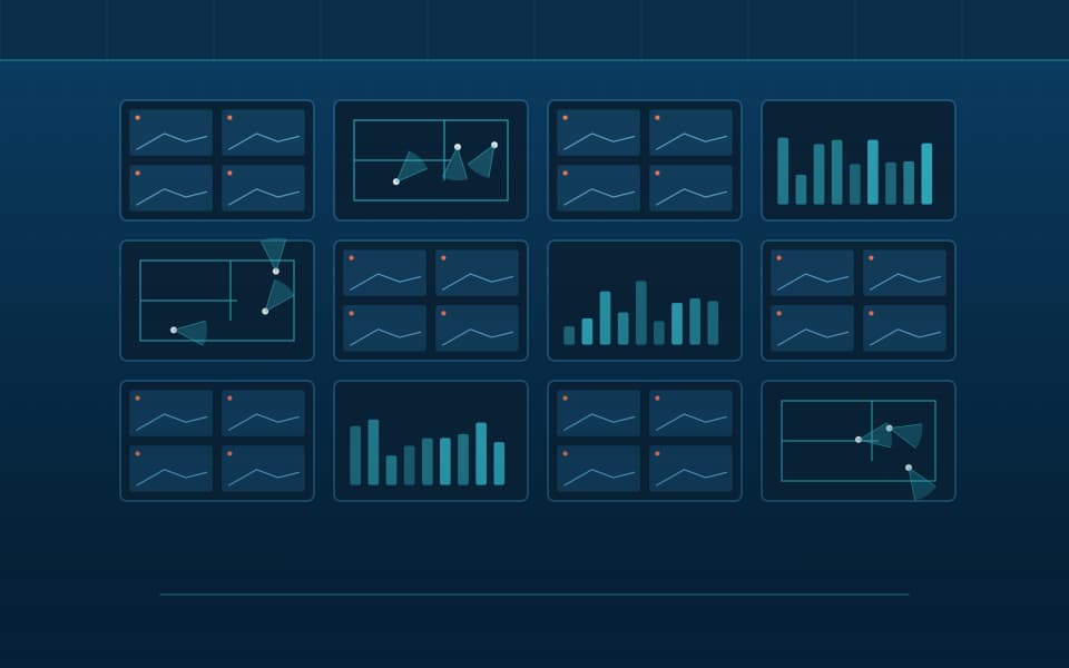 Video wall in a monitoring room showing camera views and floor plans, at night