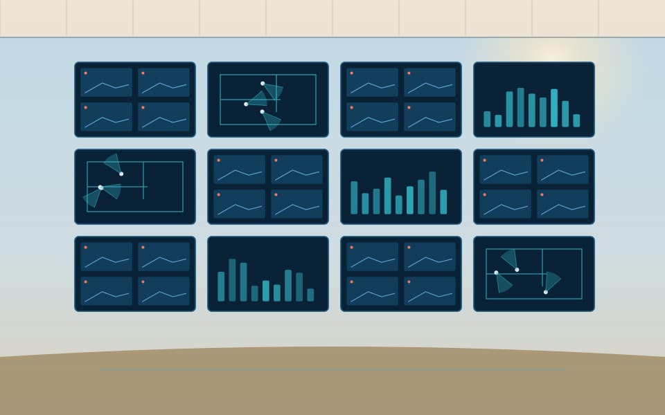 Video wall in a monitoring room showing camera views and floor plans, in daylight