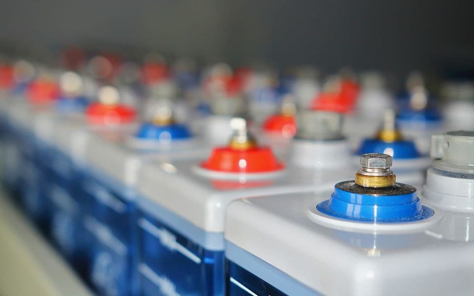 Industrial backup battery storage rows mounted on racks with terminals