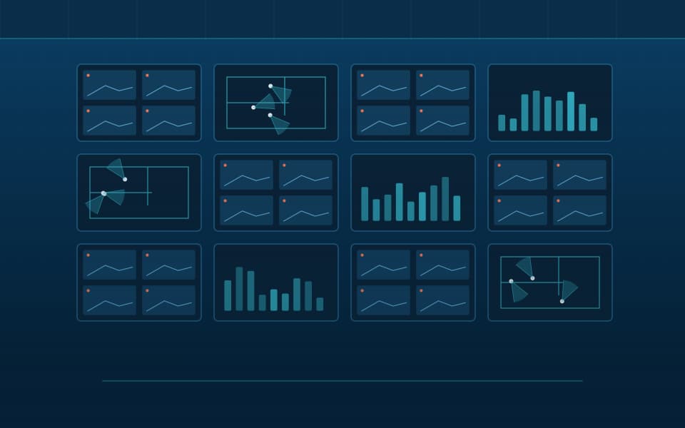 Video wall in a monitoring room showing camera views and floor plans, at night