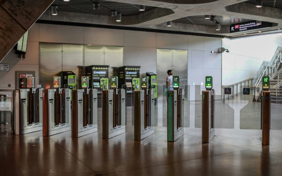 A row of optical speed gates and access barriers in a modern entrance hall