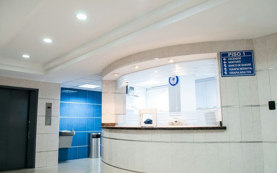 A clean hospital lobby and reception area with directory signage